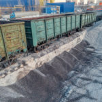 A platform for unloading inert materials from freight railway cars. Crushed stone unloading. Aerial view. Precast concrete plant.