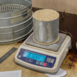 Sand tray on a laboratory balance. Testing laboratory of building materials.